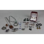 A collection of silver and white metal jewellery to include an amber pendant on a silver chain and