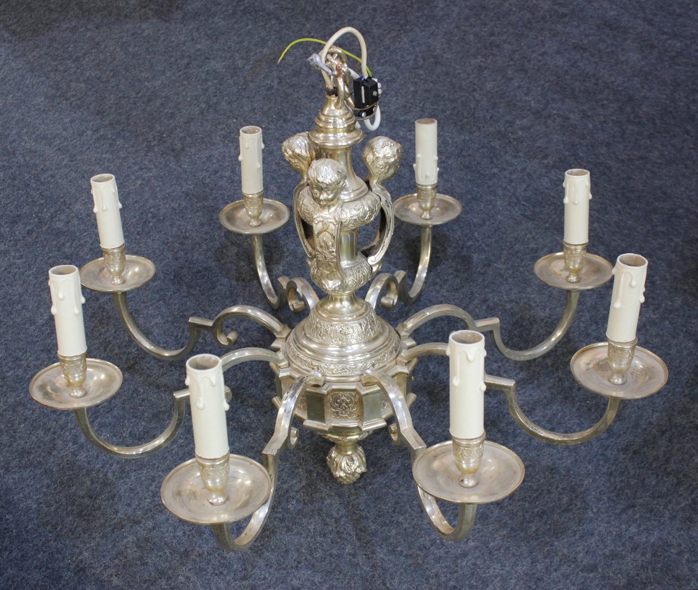 A silver plated 'Knole' eight light chandelier the stem decorated with cherub mounts, with scroll