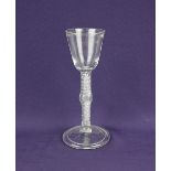 An 18th century wine glass with air twist knop stem on folded foot 17cm high