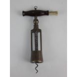 A George Twiggs patent two-pillar bronze corkscrew with wooden handle and brush, pillars stamped G