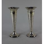 A pair of Edward VII silver vases tapered shape with hammered decoration and flared rims on circular