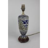 A Doulton Lambeth glazed stoneware table lamp of baluster form on wooden stand, with foliate