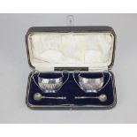 A cased pair of George V silver salt cruets oval demi-fluted with twin scroll handles, John Dixon
