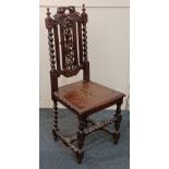 A carved oak hall chair pierced back carved with fruit and vines, solidseat on spiral turned