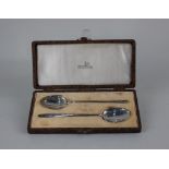 A cased pair of George V silver teaspoons with plain bowls and long slim handles, maker Walker &