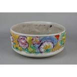 A Clarice Cliff for Newport pottery fruit bowl with moulded decoration of flowers on cream