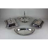 Two silver entree dishes and covers a pierced oval basket on pedestal base and an oval dish, 34cm