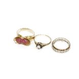 A sapphire and cubic zirconia cluster ring set in 9ct gold, and a ruby flower dress ring set in
