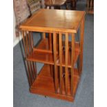 An Edwardian mahogany inlaid revolving bookcase with two tiers of shelves, on castors 46cm