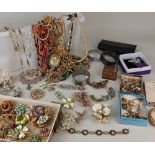 A large quantity of costume jewellery to include diamante brooches, beads, bracelets, earrings,