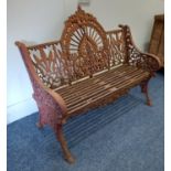 A cast iron garden bench with pierced decoration and slatted iron seat on outswept legs 118cm *