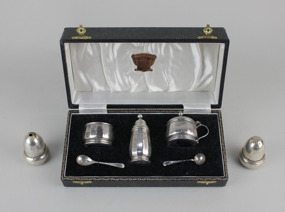 A cased modern silver three piece cruet set circular facetted form, Birmingham 1955 and a pair of