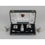 A cased modern silver three piece cruet set circular facetted form, Birmingham 1955 and a pair of