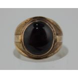 A purple sapphire cabochon dress ring set in yellow metal 15.2g