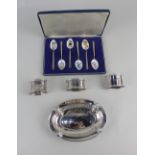 A George V silver pierced oval dish Birmingham 1924, a pair of 84 silver napkin rings, a single