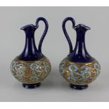 A pair of Royal Doulton Slaters Patent jugs, blue glazed with band of textured floral decoration and