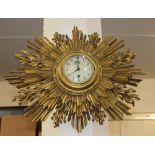 A starburst gilt framed wall clock the circular dial with Arabic numerals approx 59cm wide (a/f)