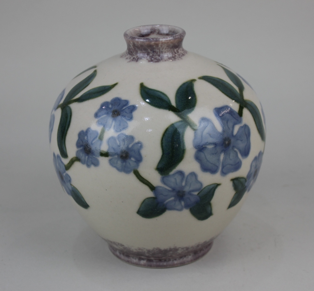 A Cobridge stoneware perriwinkle vase decorated with blue flowers on cream ground 16cm high