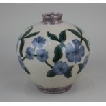 A Cobridge stoneware perriwinkle vase decorated with blue flowers on cream ground 16cm high