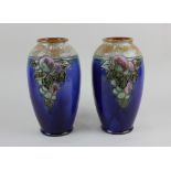 A pair of Royal Doulton glazed stoneware vases possibly by Maud Bowen with tubelined decoration of