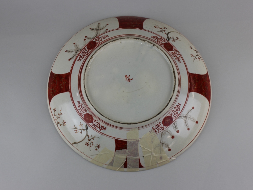 A Japanese Kutani porcelain plate decorated with panels of figures and flowers, character marks - Image 2 of 2