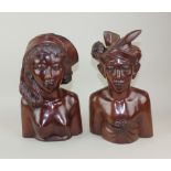 A pair of Balinese carved hardwood busts of a young man and woman verso inscribed 'A A Fatimah Bali'