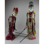 A pair of Indonesian rod puppets of Sita and Rama on wooden stands 62cm high