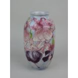 A Cobridge stoneware vase decorated with fuchsia on blue ground, 22cm high