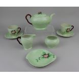 A Carltonware 'Wild Rose' pattern tea service comprising teapot, milk jug, sugar bowl, two teacups