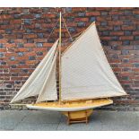 A large painted wooden model of a yacht with three sails on stand 174cm