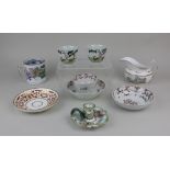 A New Hall porcelain tea bowl and two saucers with floral decoration, a pair of porcelain tea