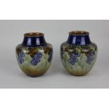 A pair of Royal Doulton glazed stoneware vases decorated with fruiting vines 18cm high