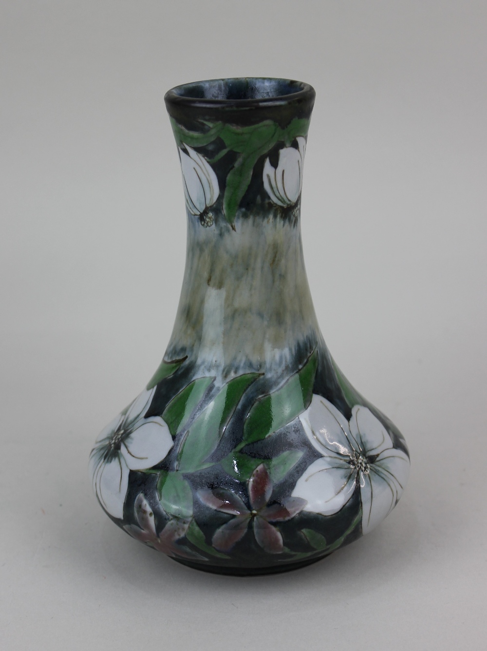 A Cobridge stoneware Mexican Orange blossom vase, with floral decoration on blue mottled ground 18.