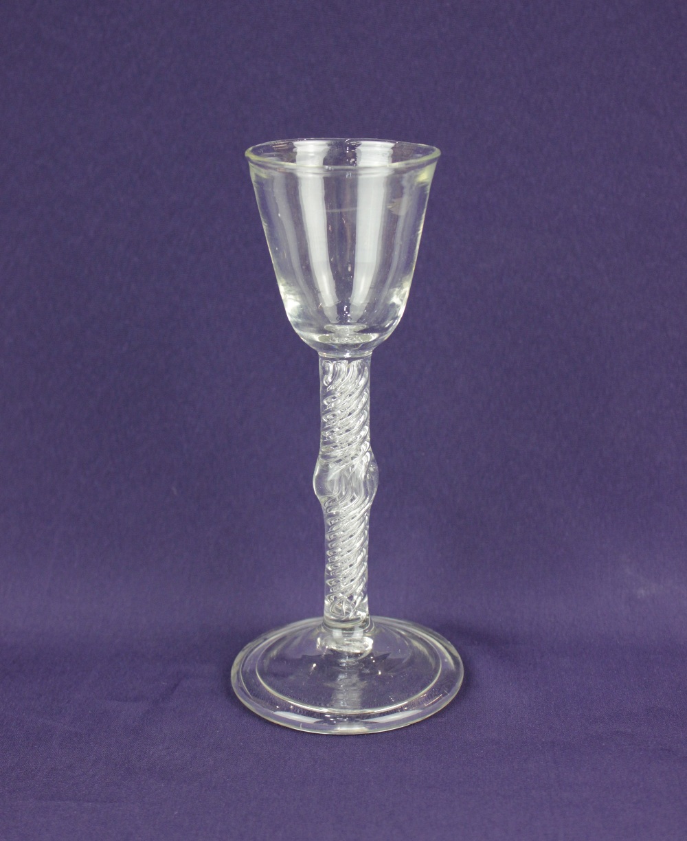 An 18th century wine glass with air twist knop stem on folded foot 17cm high