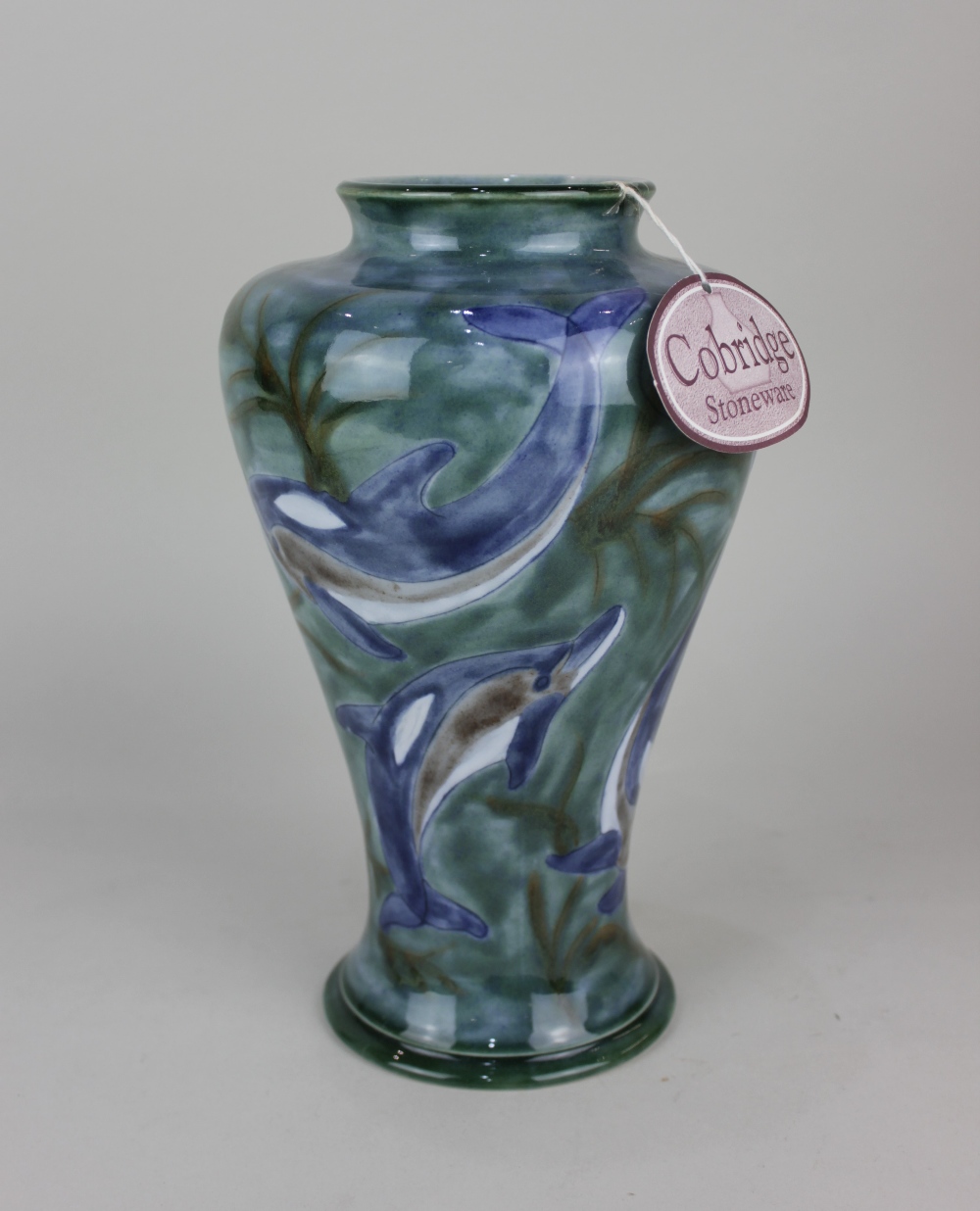 A Cobridge stoneware 'Ocean Travellers' vase decorated with dolphins on blue ground 26.5cm high