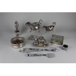 A collection of silver plated tableware to include two sauce boats, sugar castor, three-piece