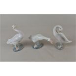 Three Lladro porcelain models of white ducks in various poses, tallest 13cm high, two with boxes