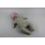 An Armand Marseille bisque head doll on stuffed body 42cm long (a/f - missing eyes and hand)