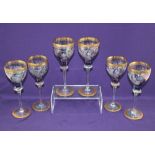 A set of six Bohemian Mirea crystal wine glasses each with iridescent blue bowl decorated with