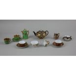 A miniature Royal Crown Derby Imari porcelain teapot, two tea cups and saucers and a mug, together