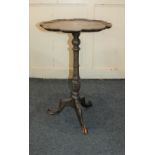 A George III style mahogany tripod wine table with circular pie crust top on baluster stem and