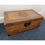 A Chinese carved camphor wood trunk the top with deeply carved dragon medallion centre and border,