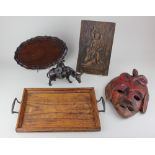 A wooden panel with carved figural decoration verso partial paper labels 28cm by 17cm, together with