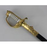 A Royal Navy Officer's dress sword by Gieves engraved A C Cowin RN, in brass mounted leather