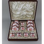 A Royal Crown Derby porcelain coffee set decorated in the Imari palette with gilt embellishments,