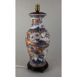 A Japanese Imari porcelain vase converted to a table lamp, on wooden stand 48cm high including