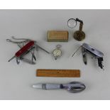 A Swiss Army multi tool pen knife and another similar, together with a map measurer, boxed, a