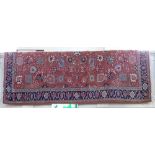 A Turkish Kozak rug terracotta field with all over floral design and blue patterned border, with