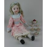 A bisque head doll with blonde hair and painted features, wearing a pink dress 46cm tall, together