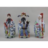 Three Chinese ceramic figures of gods with gilt embellishments 25.5cm high (a/f)